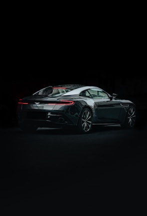 An elegant sports car displayed under soft ambient lighting.