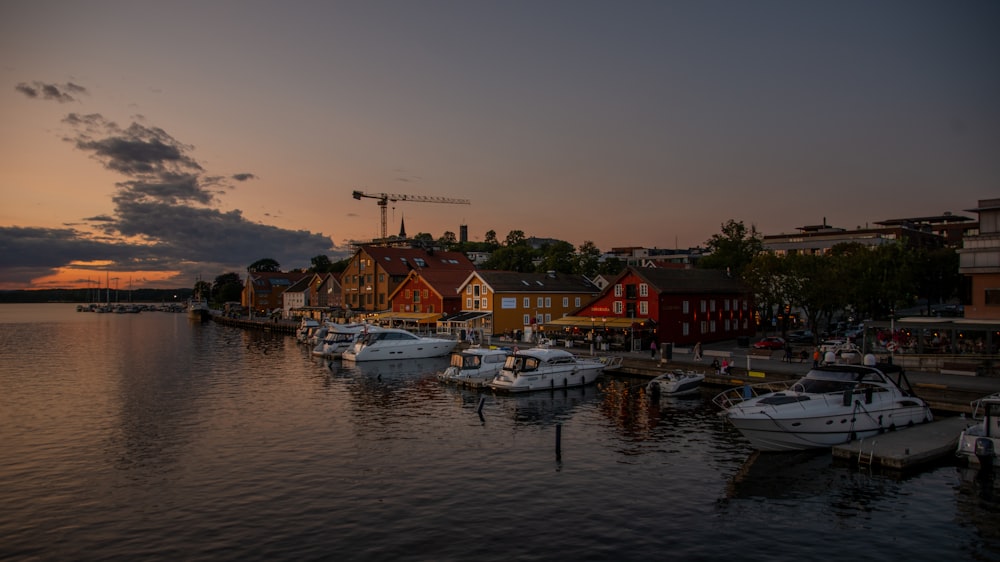 a harbor filled with lots of boats under a cloudy sky