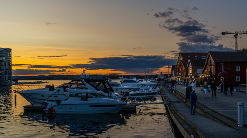 a group of boats parked next to a pier