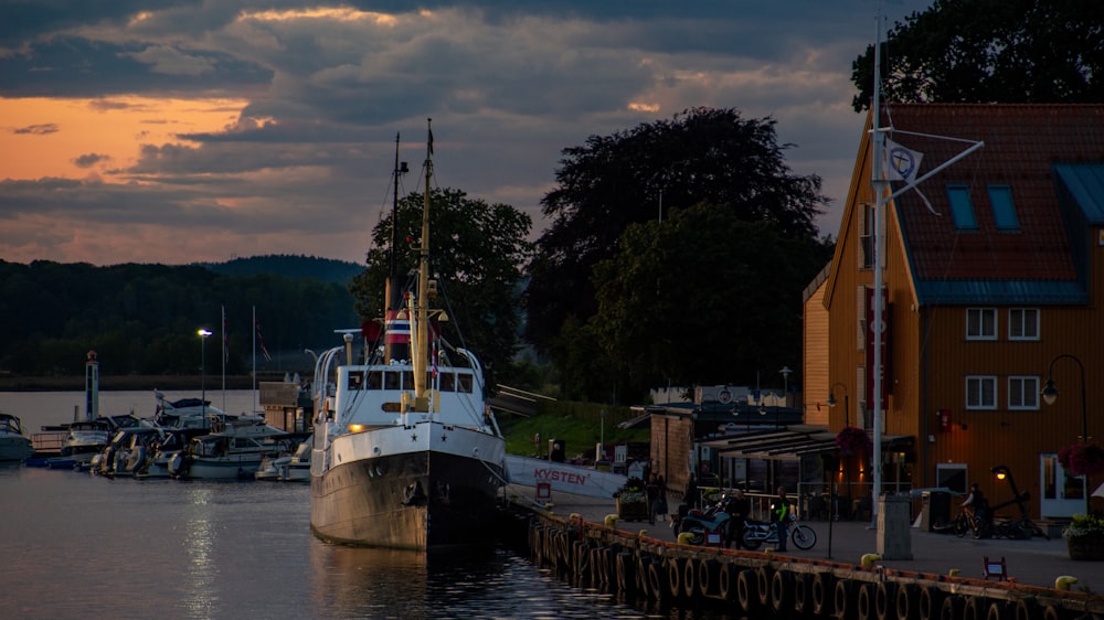 a boat docked at a dock in a harbor