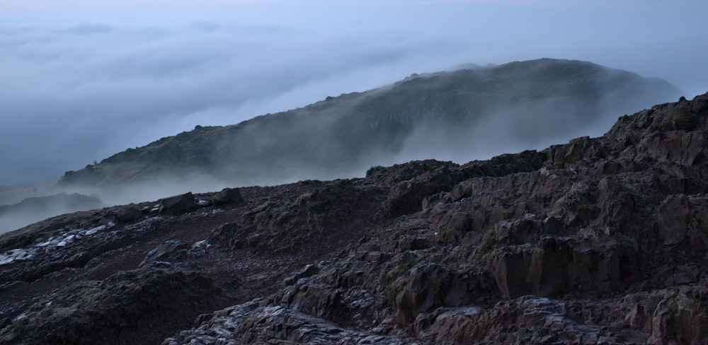 a mountain covered in fog and low lying clouds