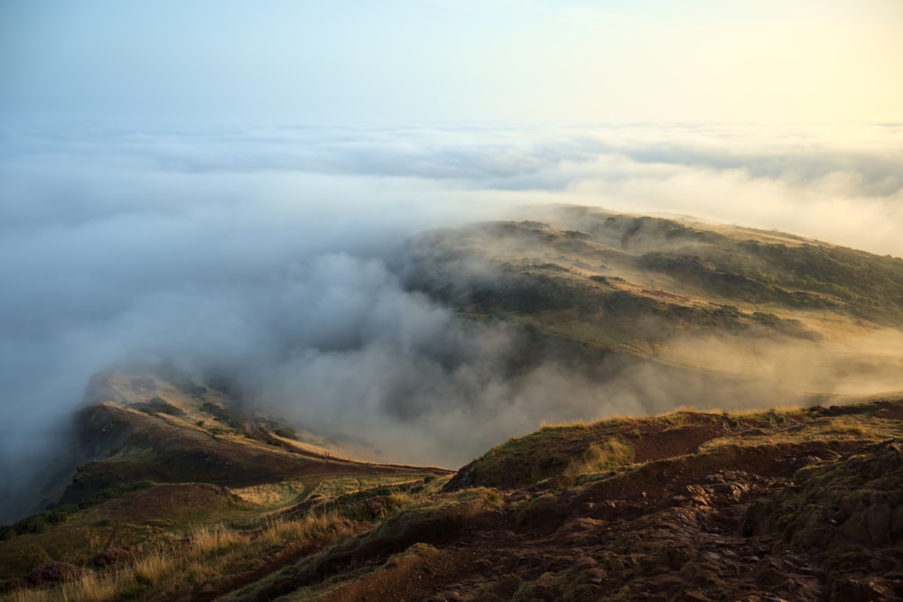 a view of a mountain covered in low lying clouds