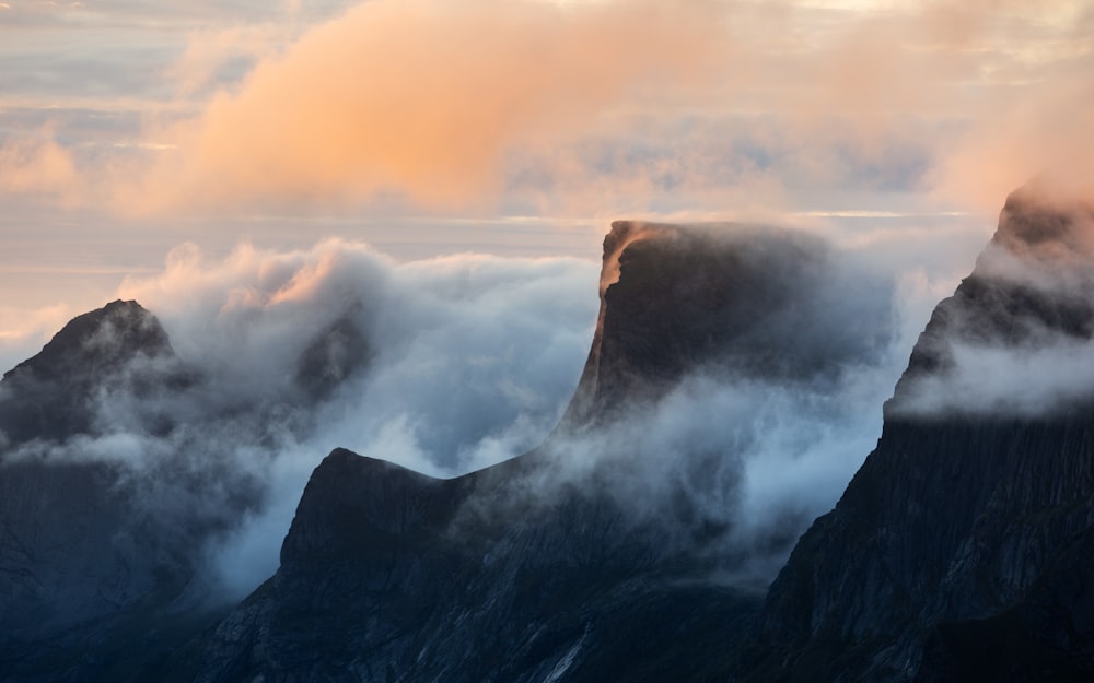 a mountain range covered in clouds and mist