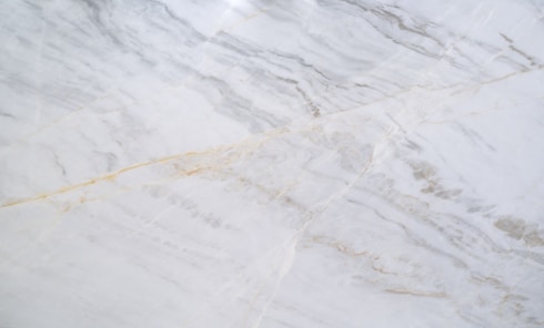 a close up of a white marble counter top