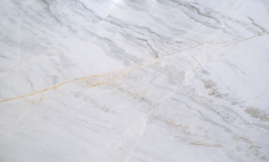 a close up of a white marble counter top