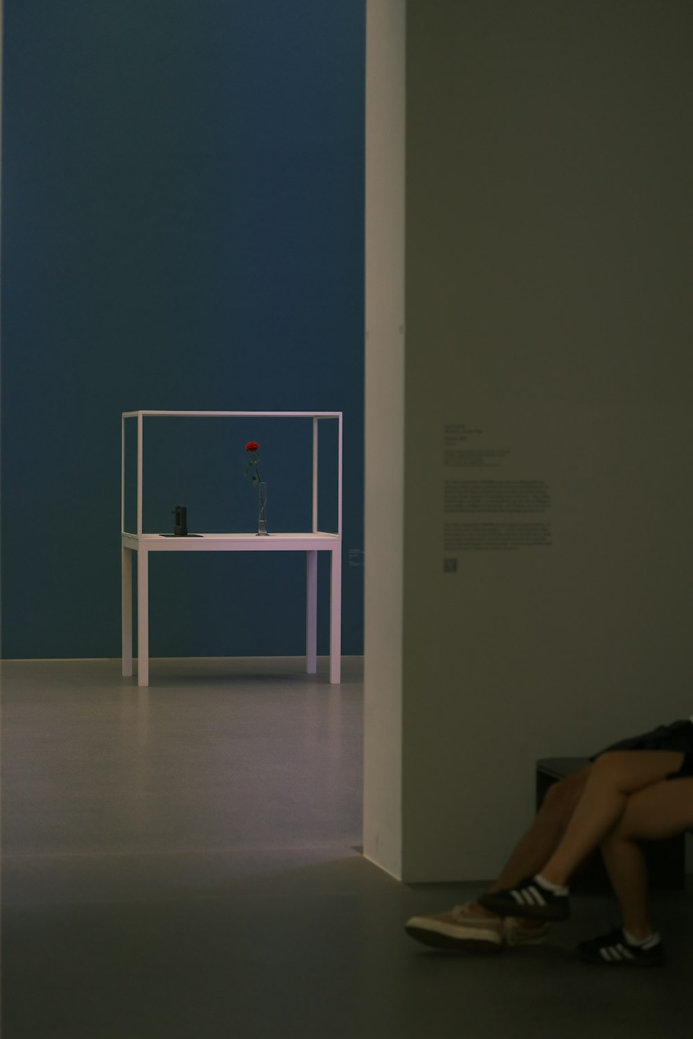 a woman sitting on a bench in a room