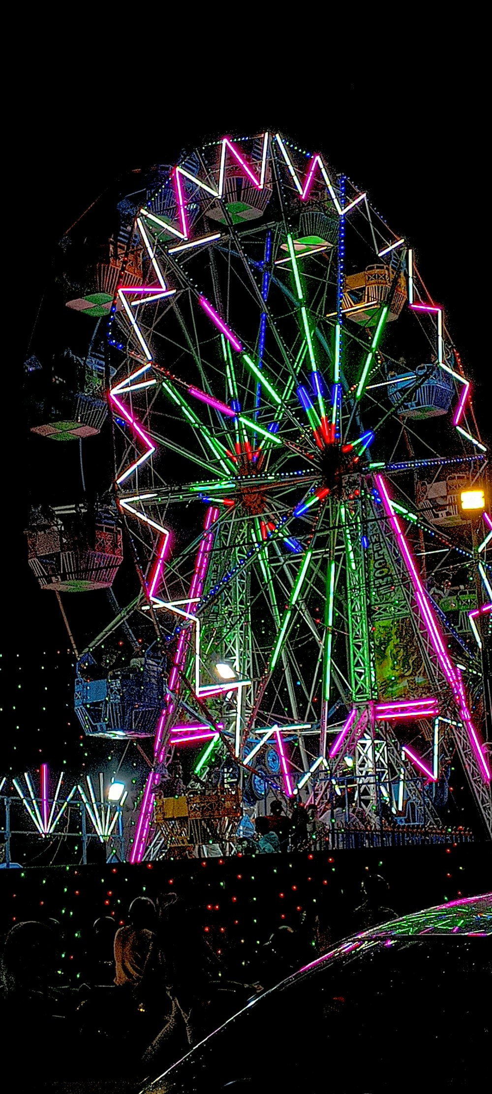 a large ferris wheel lit up at night