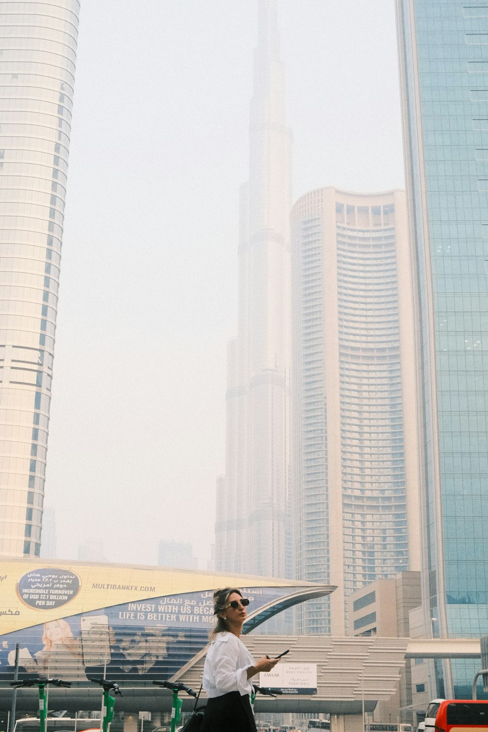 a man walking in front of a tall building