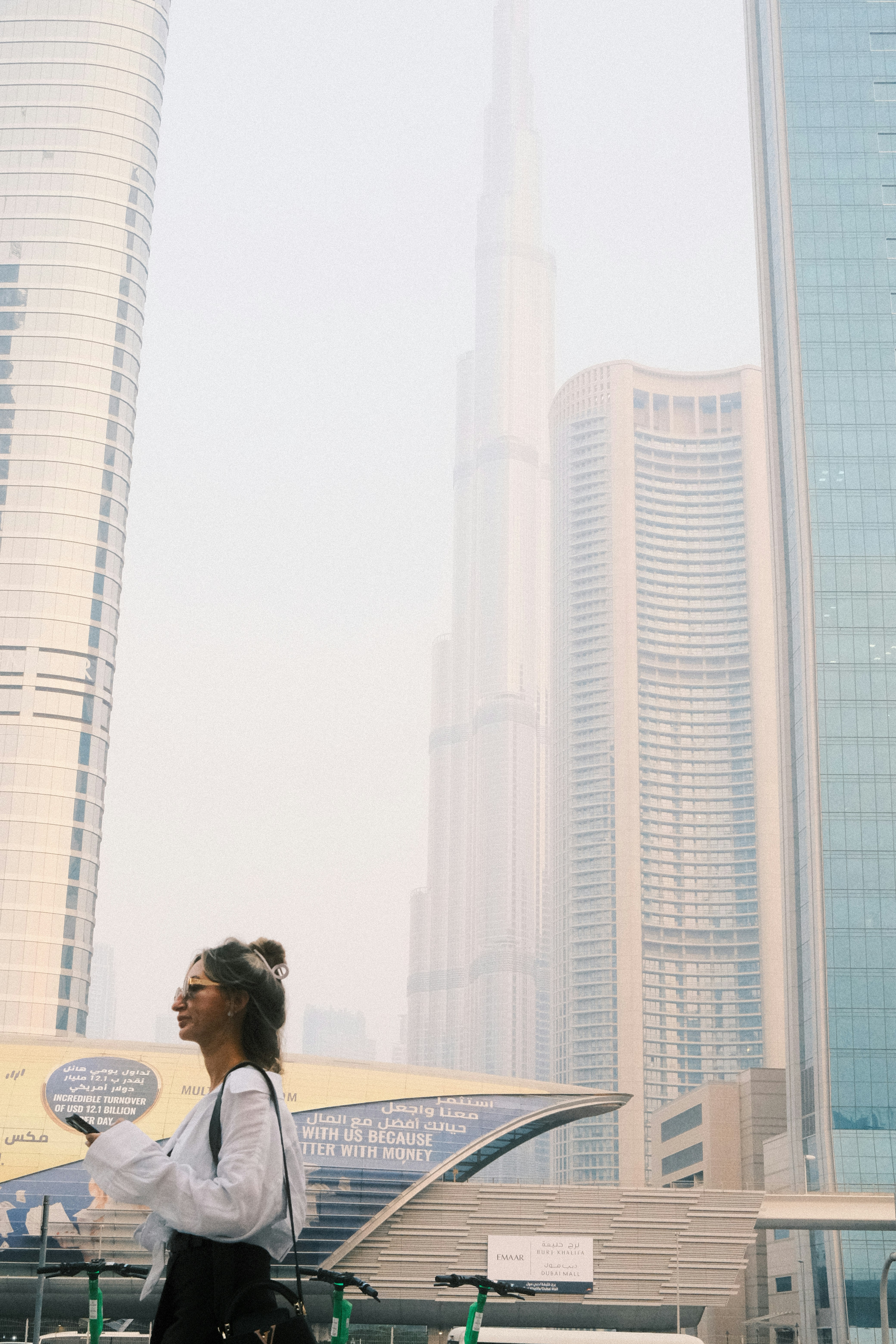 a woman standing in front of a tall building