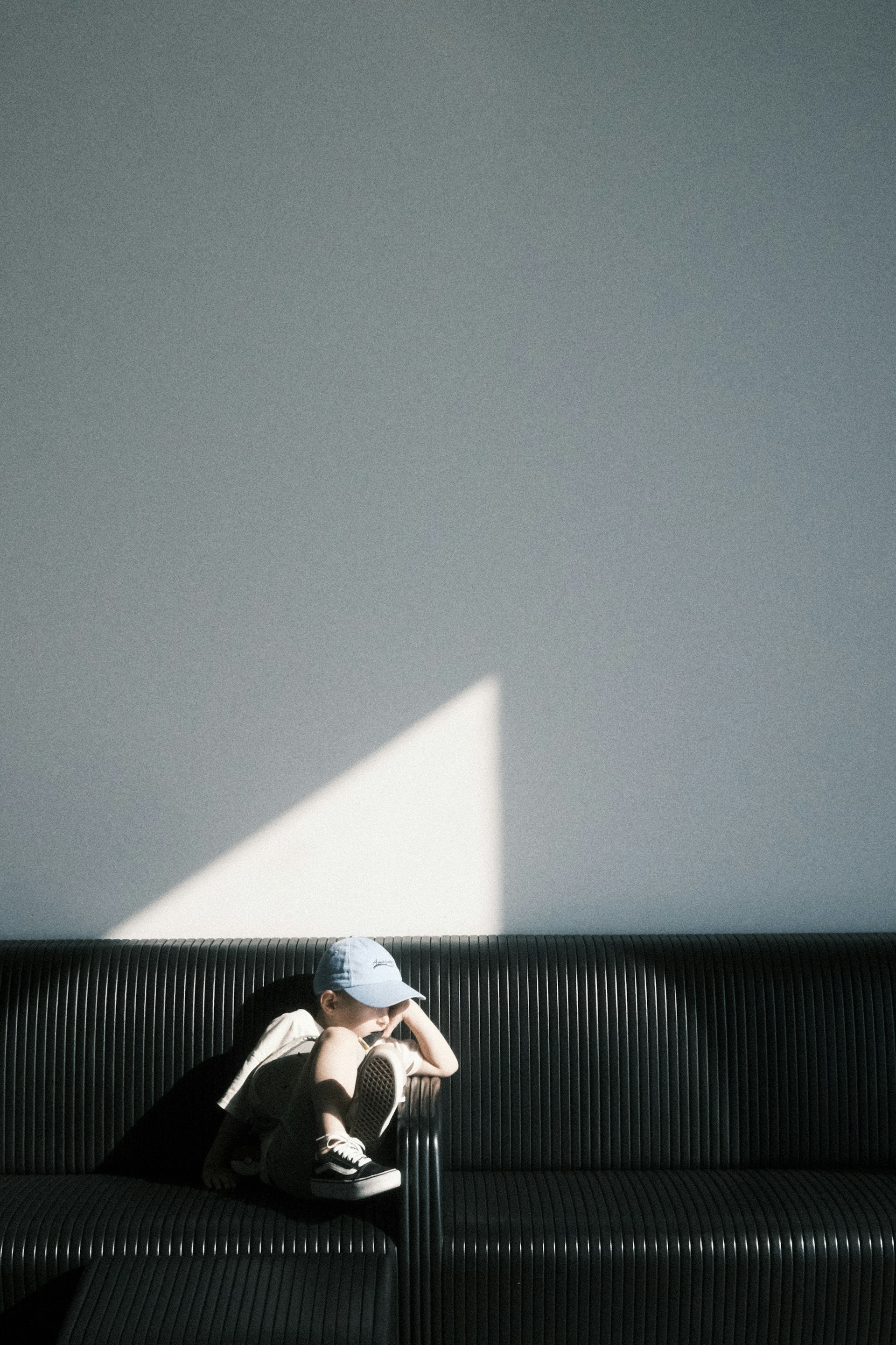 a man sitting on top of a black couch