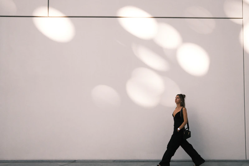 Woman walking along a city sidewalk