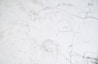 A smooth white surface with subtle gray veining patterns, resembling a marble texture. The image conveys a clean and elegant appearance, with a natural and sophisticated aesthetic.