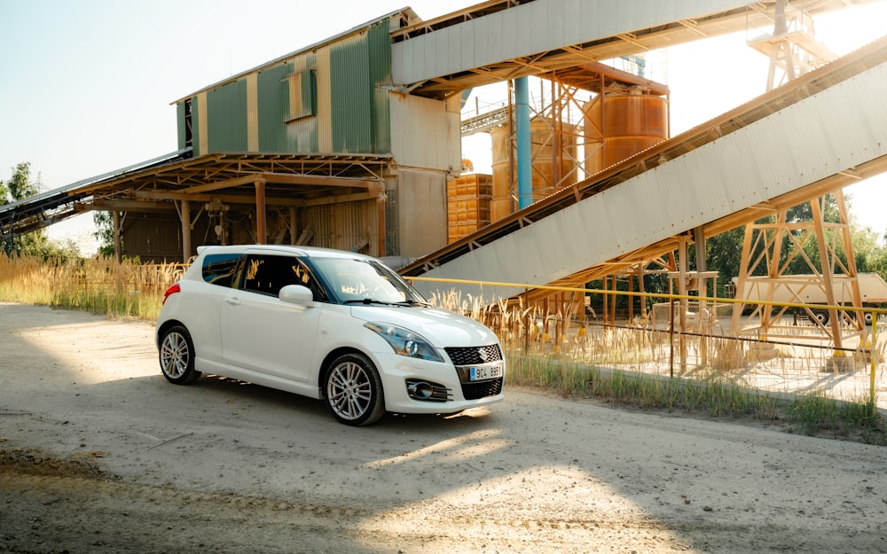 a small white car parked in front of a building