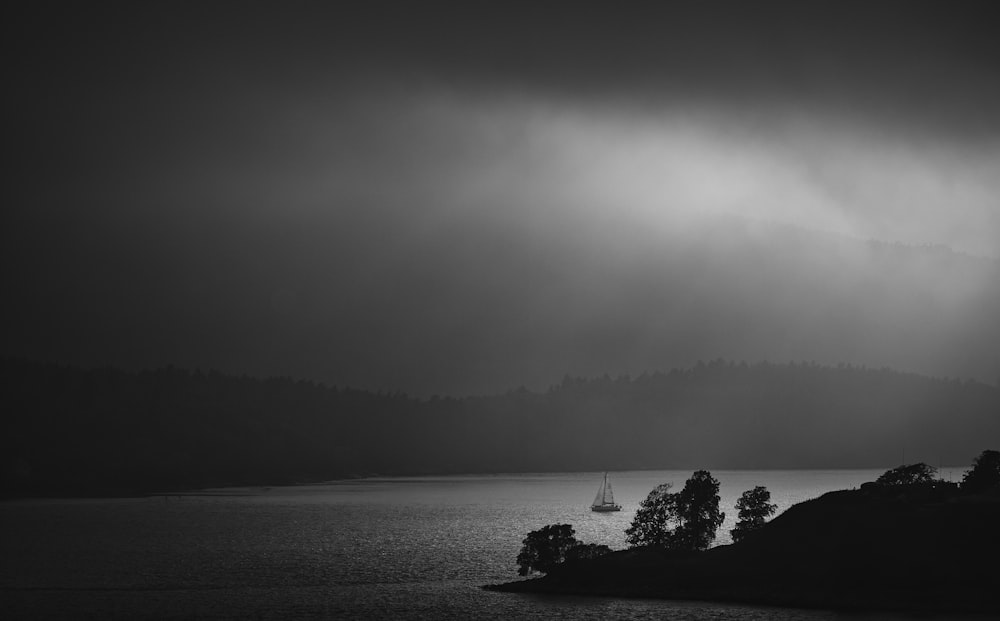 a black and white photo of a boat in the water