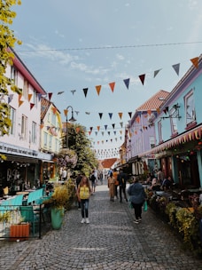 Cobblestone streets lined with colorful tiles and lively street musicians.