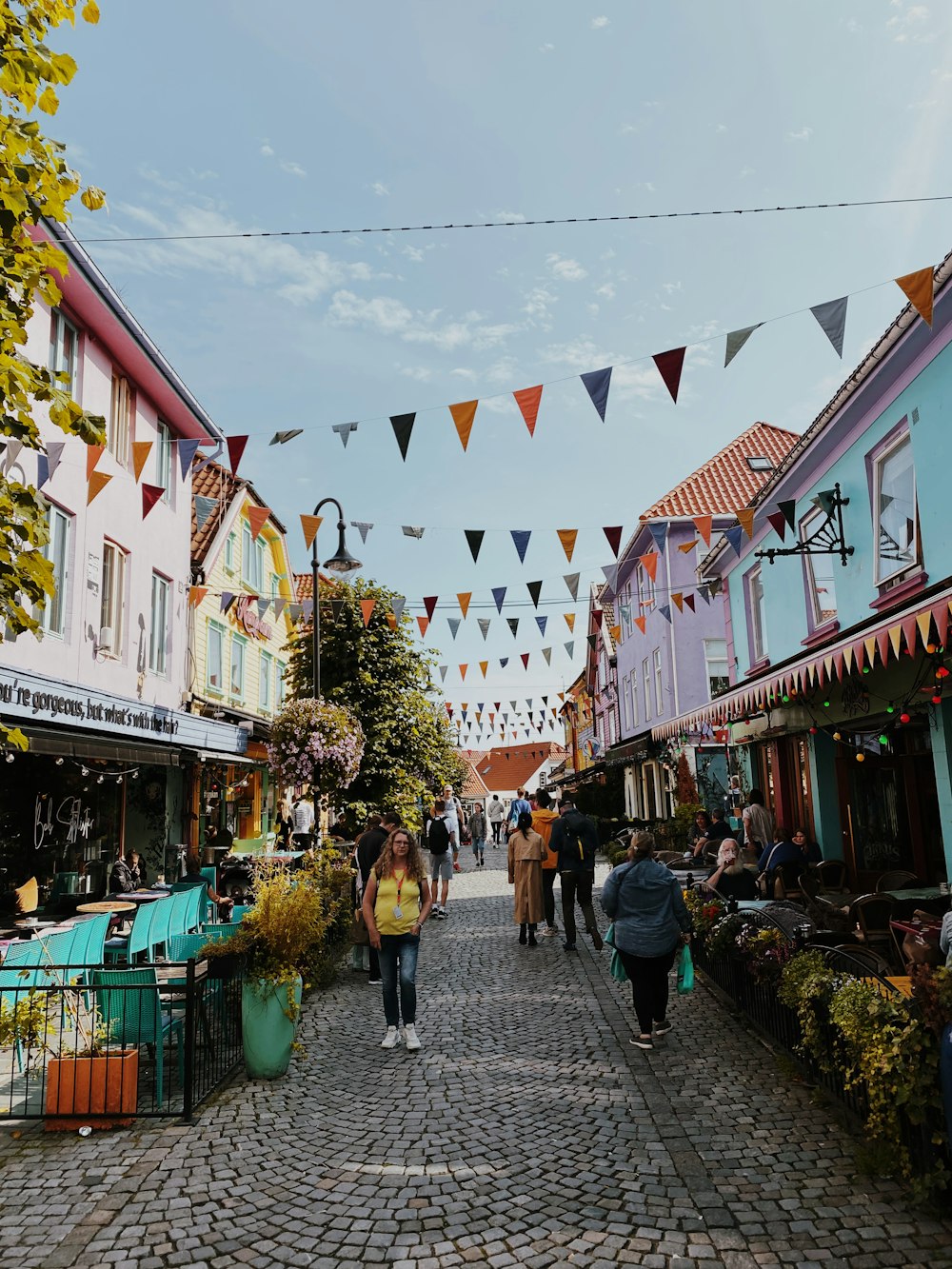 a group of people walking down a cobblestone street