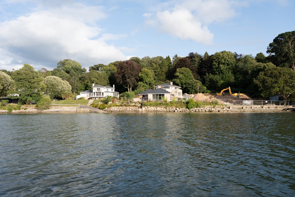 a large body of water with a house in the background