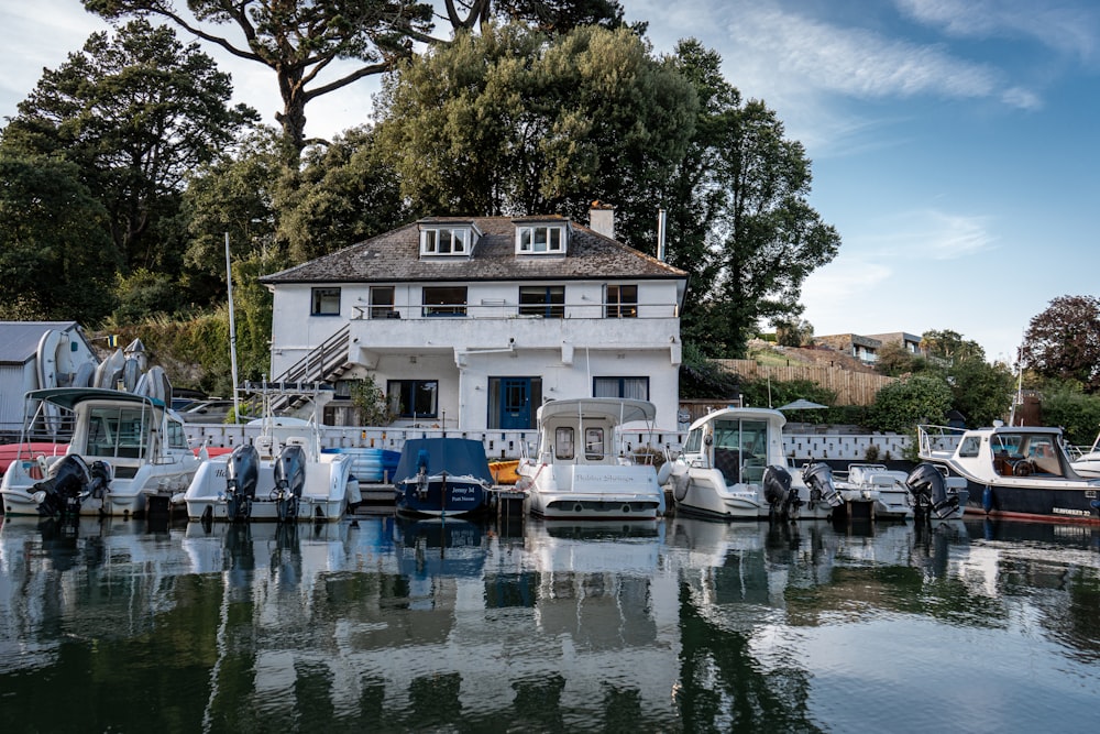 a group of boats parked in front of a house