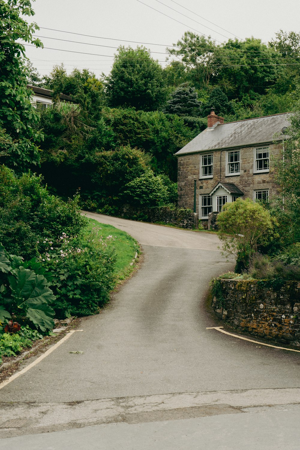 a stone house in the middle of a wooded area