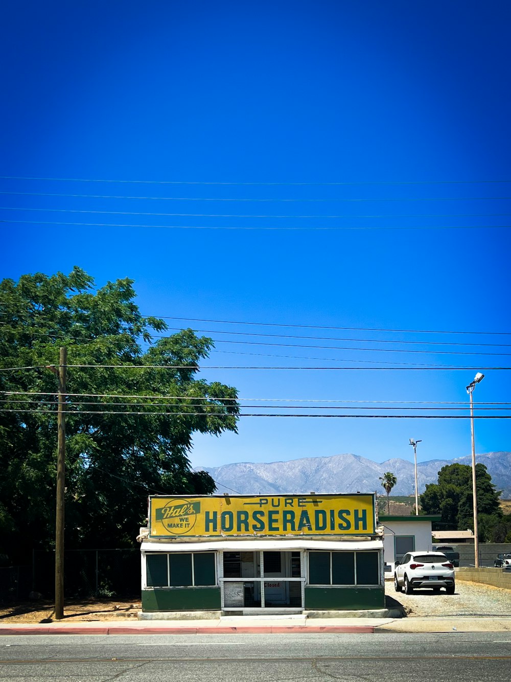 a gas station with a car parked in front of it