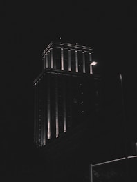 A commercial building illuminated at night.