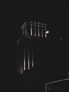 A commercial building illuminated at night.