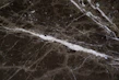 Close-up of smooth, glossy PVC marble sheets reflecting soft light
