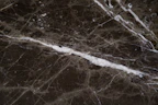 Close-up of smooth, glossy PVC marble sheets reflecting soft light