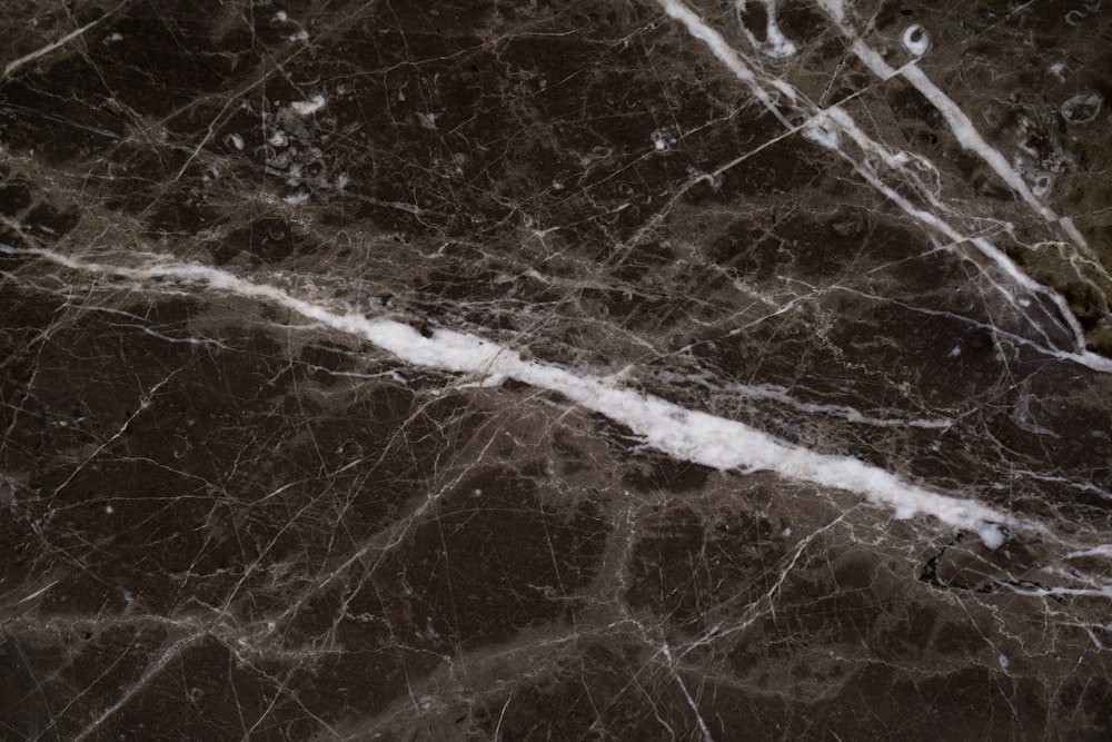 a close up of a marble surface with white lines