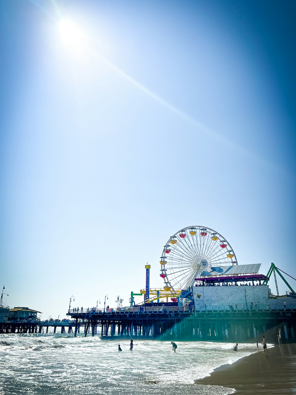 a large ferris wheel sitting next to a pier