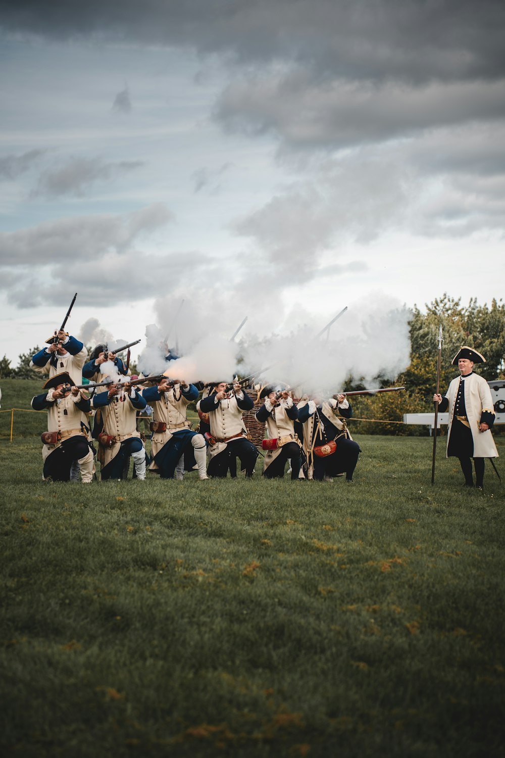 a group of men standing on top of a lush green field