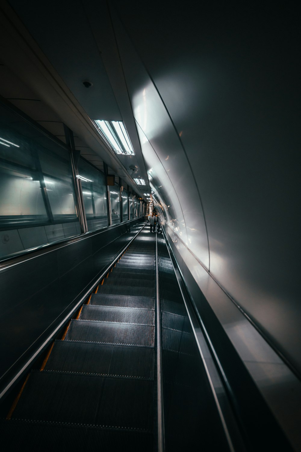 an escalator in a subway station at night