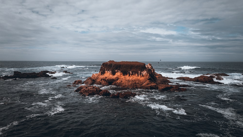 a rock outcropping in the middle of the ocean