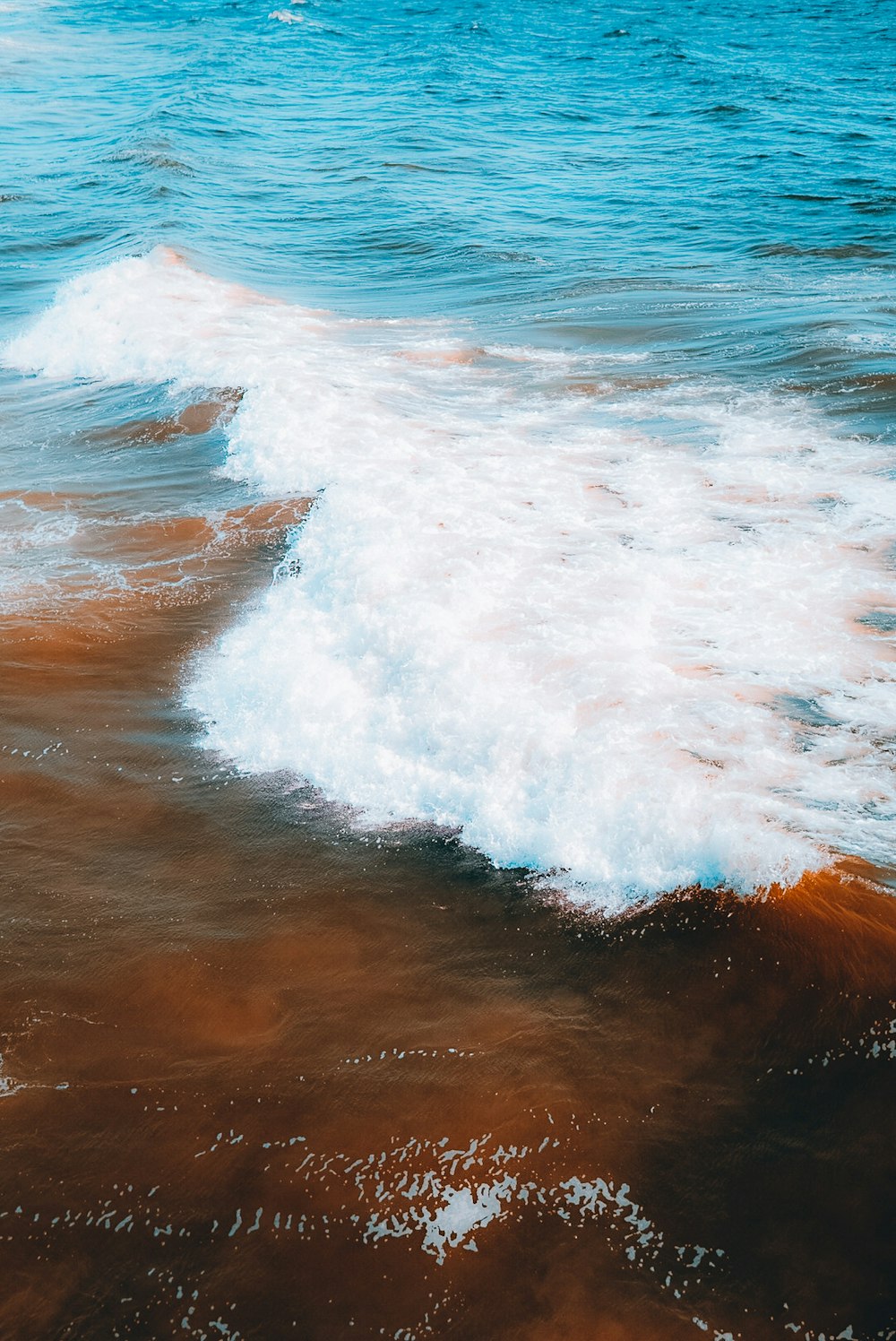 a person riding a surfboard on a wave in the ocean