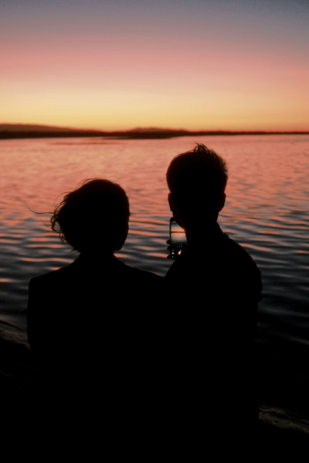 a couple of people that are standing in the water