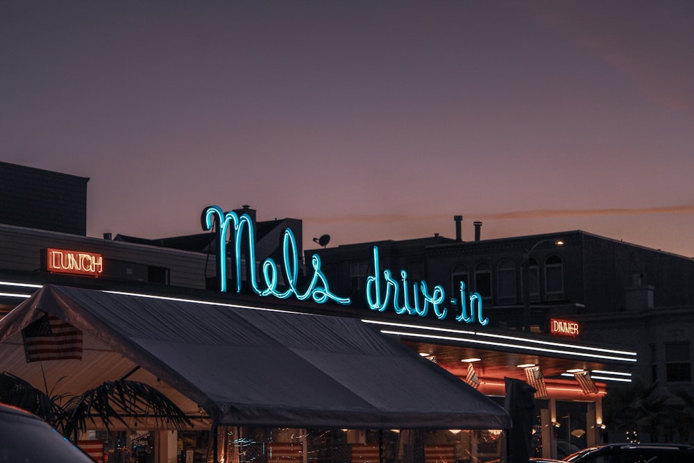 a neon sign that reads mel's drive in