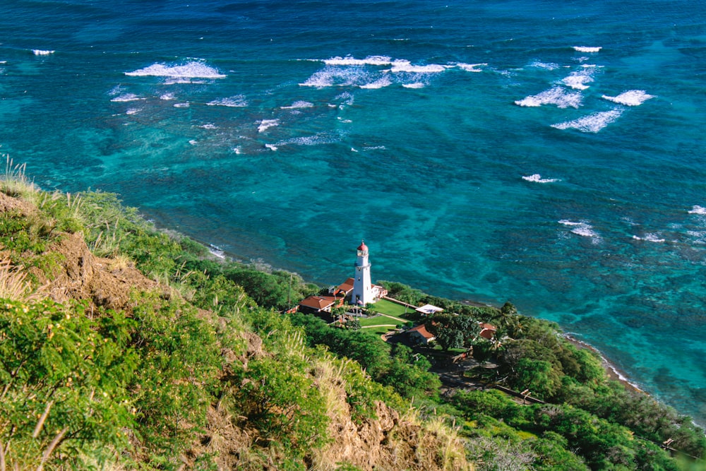 a lighthouse on a cliff overlooking the ocean