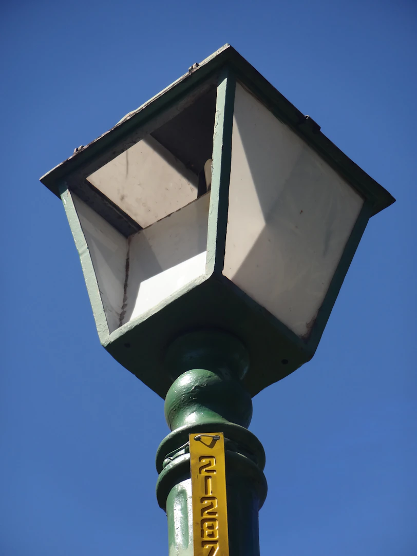 a street light with a yellow sign on it