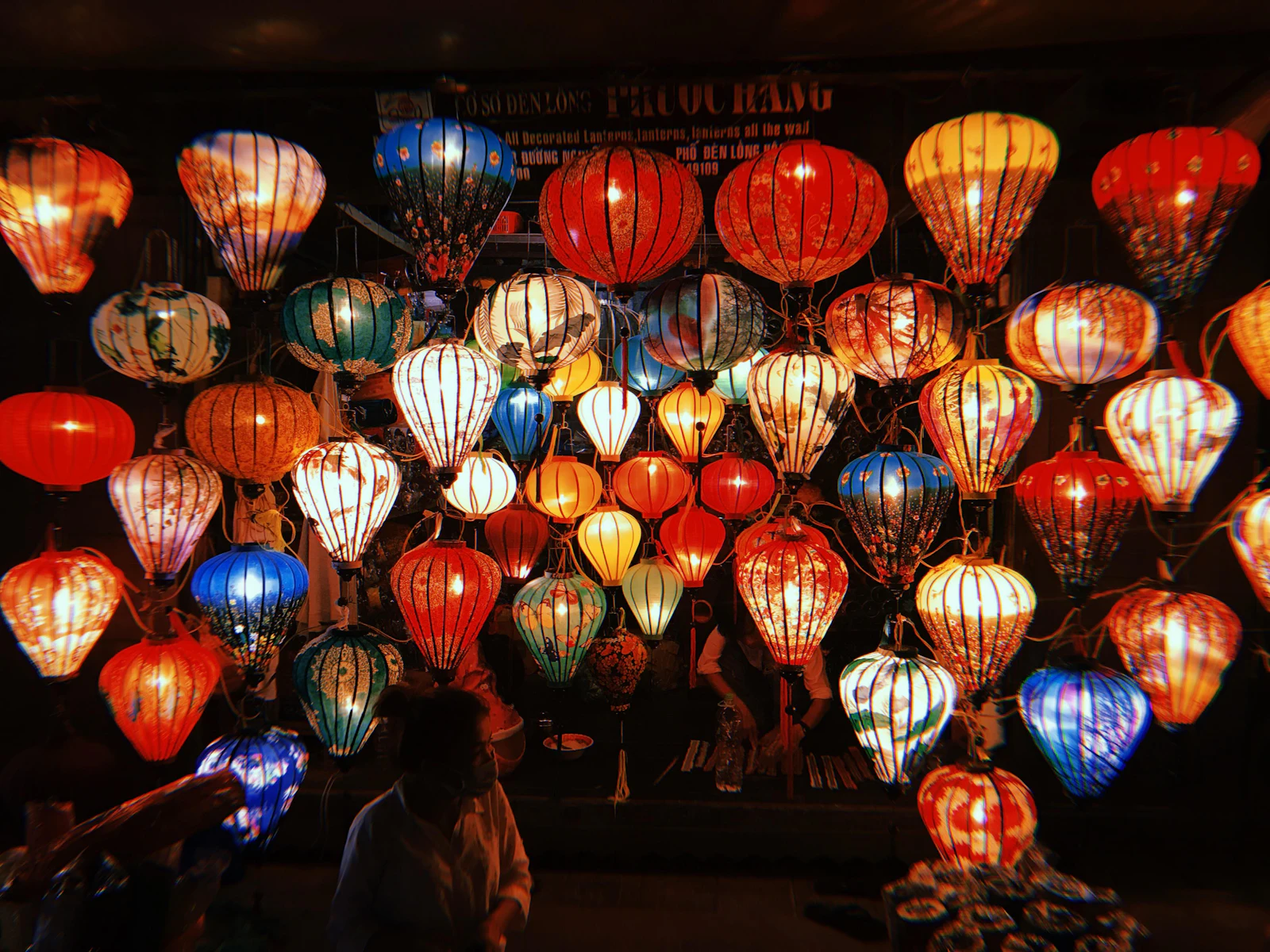 Lantern-lit merchant houses along a canal in Hội An's old town