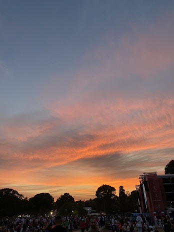 A dramatic sunset backdrop during an outdoor event.