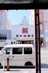 A locksmith van parked on a city street ready for emergency service.