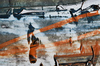 Close-up of rusted metal textures blending into shadowy, abstract shapes evoking a haunting rhythm.