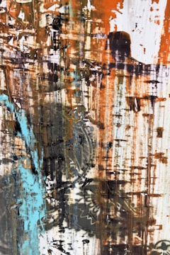 A vibrant abstract painting with bold brushstrokes in blues and oranges.