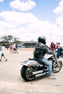 Eliza riding her Harley-Davidson down a winding road, the wind catching her hair and leather jacket.