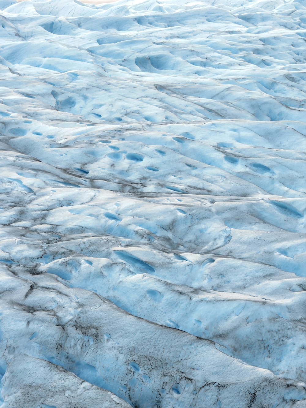 an airplane is flying over a large glacier