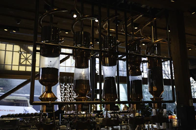 Trainer explaining coffee brewing techniques to attentive participants in a bright room.
