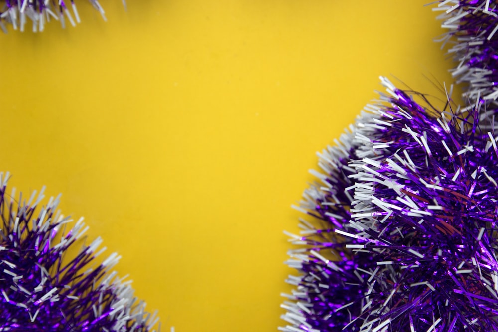 purple and silver tinsel on a yellow background