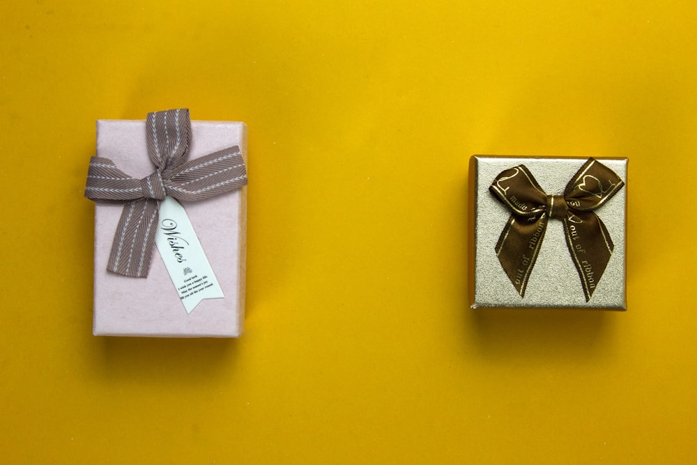 a couple of wrapped presents sitting on top of a yellow table