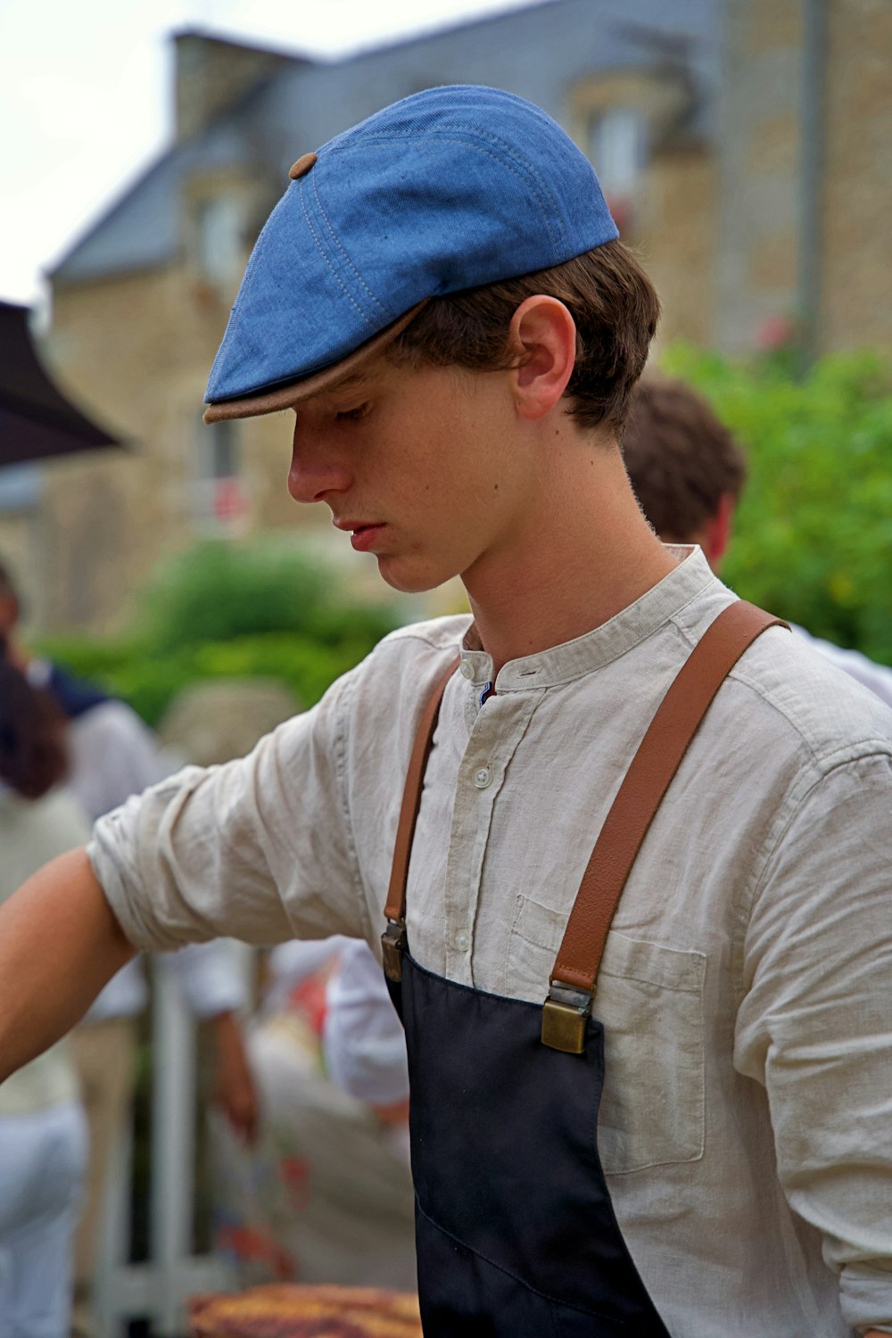 a man wearing an apron and a blue hat