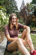 A smiling caregiver engaging with a client in a garden.